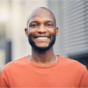 209554363-black-man-smile-and-portrait-outdoor-on-a-city-street-with-a-positive-mindset-confidence-and-freedom